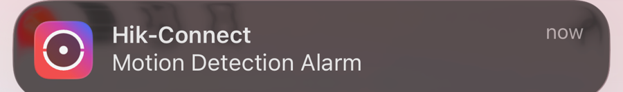 A Hik-Connect push notification on a phone reading Motion Detection Alarm.