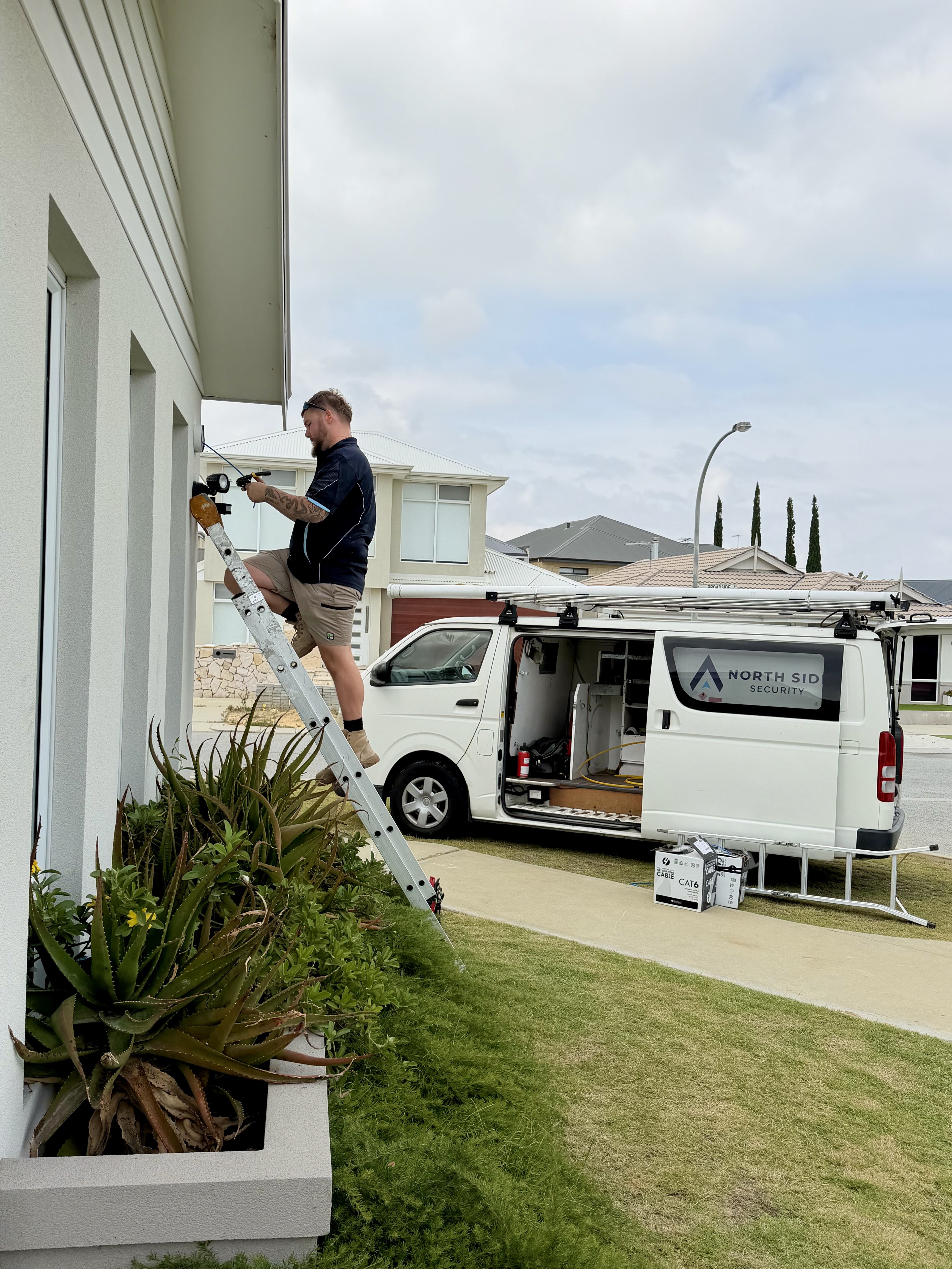 North Side Security technician installing a CCTV camera at a home in Perth's northern suburbs