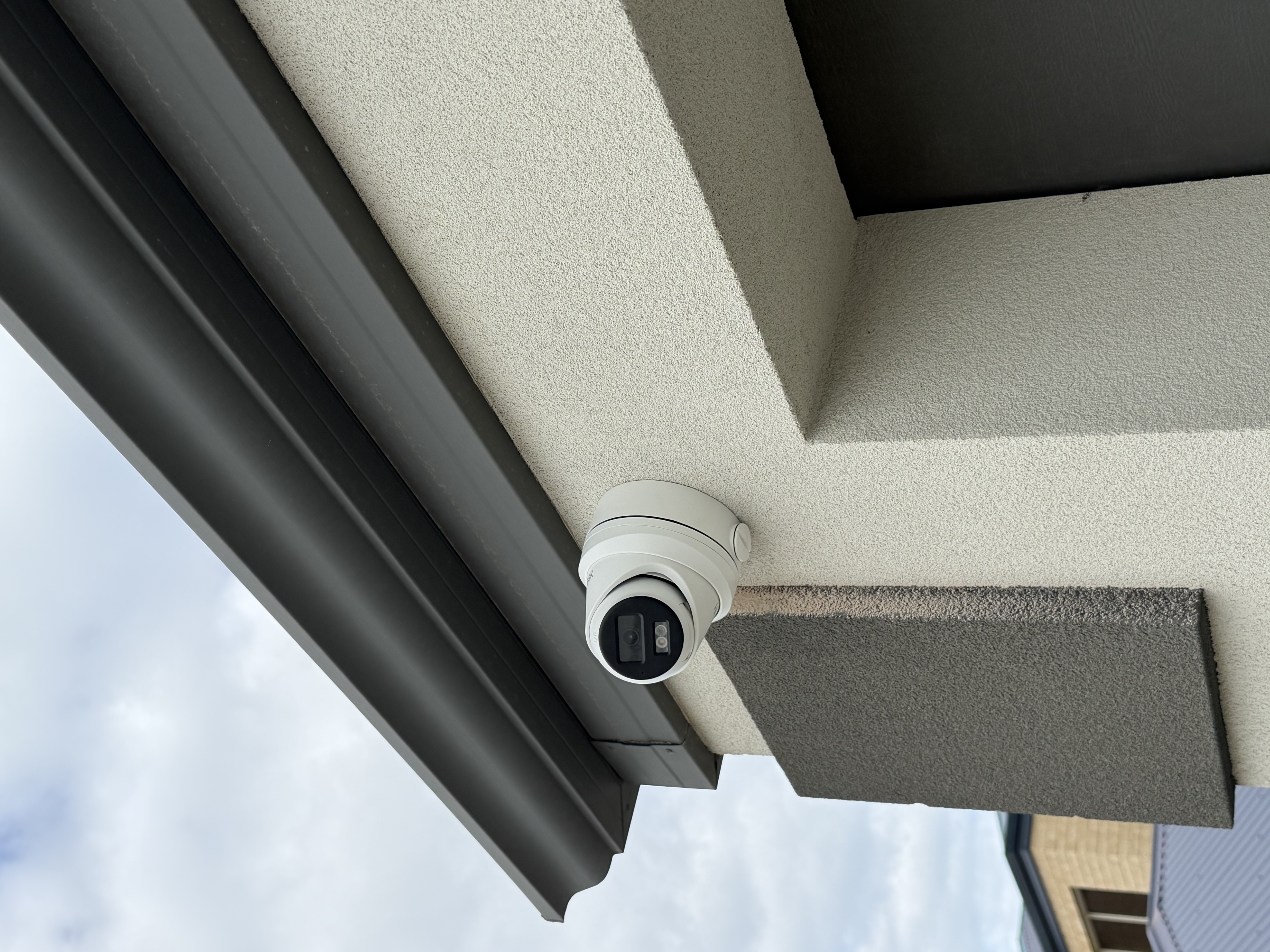 Hikvision turret CCTV camera mounted under eave corner — North Side Security Perth