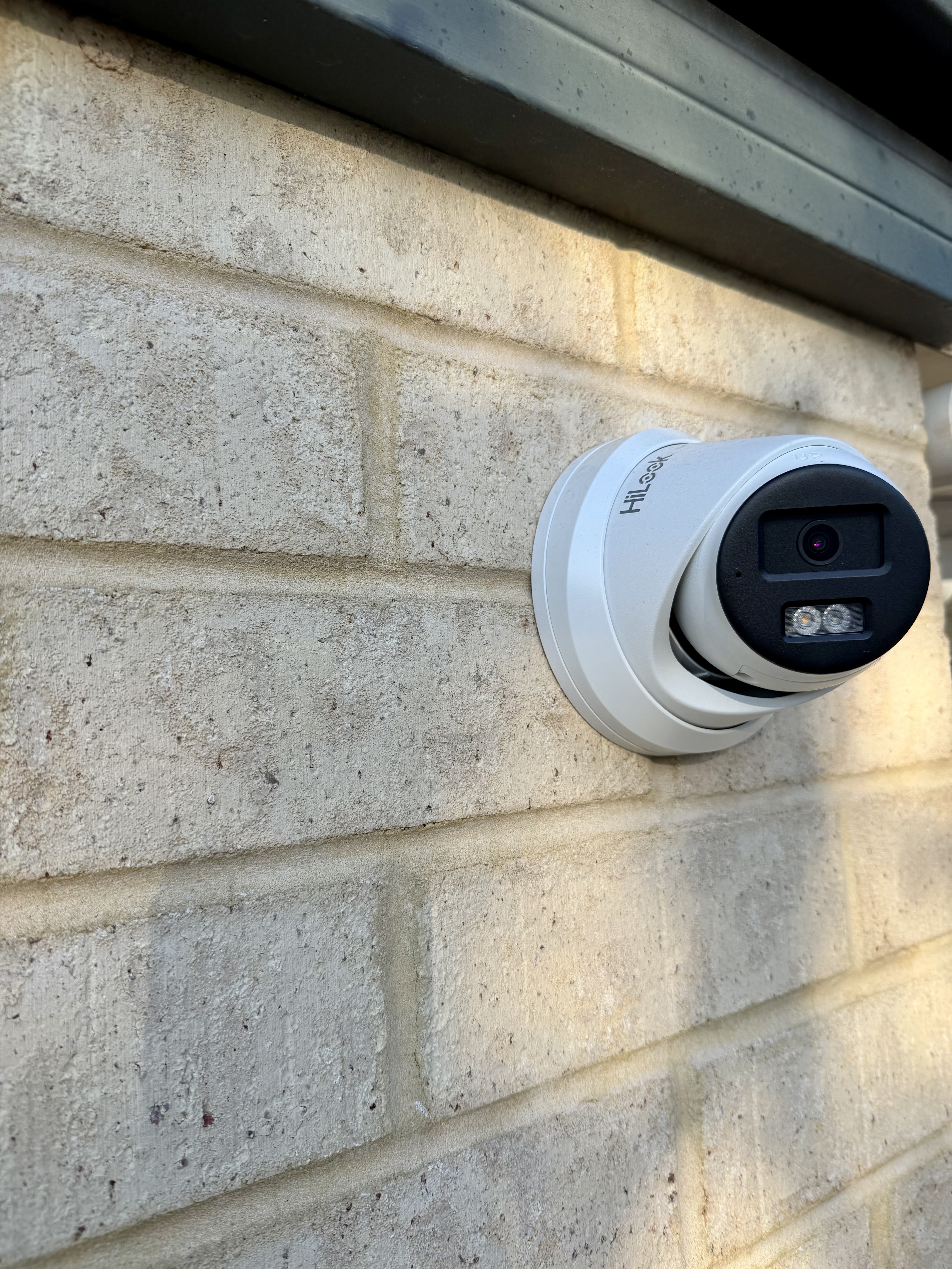 CCTV camera mounted on brick wall — clean professional install by North Side Security